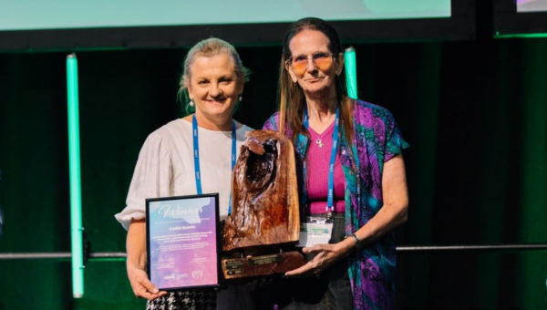 Redlands City Council Mayor Karen Williams presents the Award to Kellie Bowie