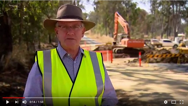 Council worker with road works in background